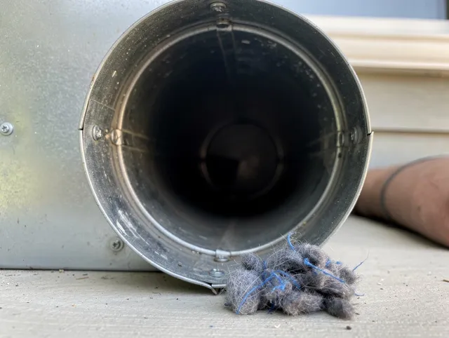 Twinsburg Dryer Vent Cleaning technician using specialized equipment to clear severe dryer vent blockage in Twinsburg
